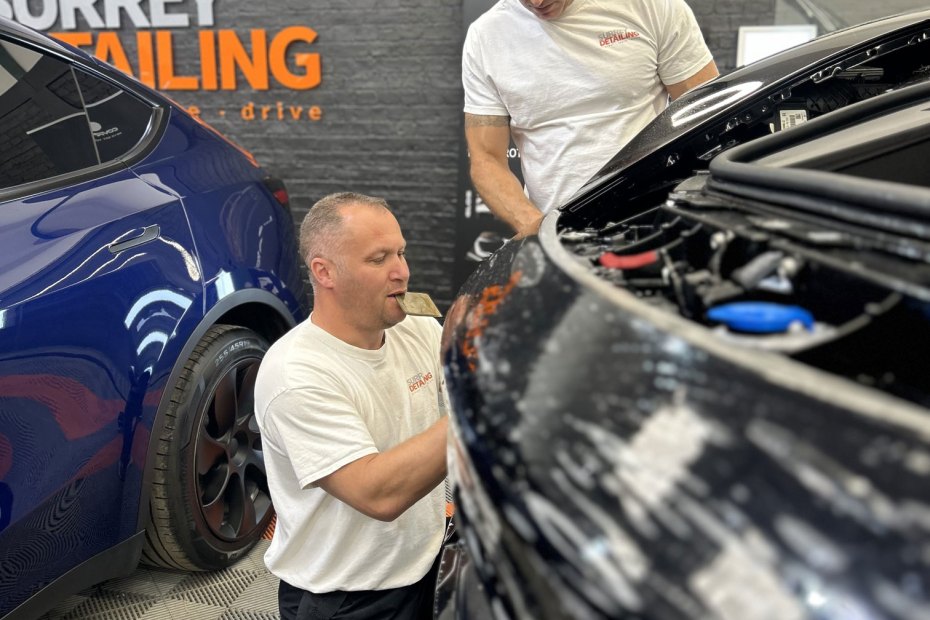 Dan and Dave cleaning a black car